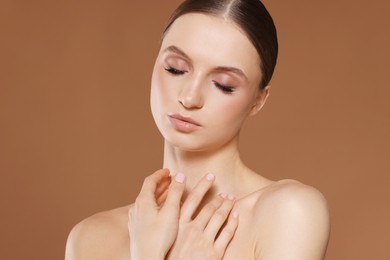 Photo of Portrait of beautiful young woman on beige background