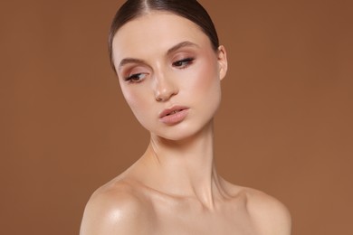 Photo of Portrait of beautiful young woman on beige background