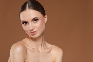 Photo of Portrait of beautiful young woman on beige background, space for text