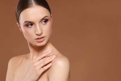 Photo of Portrait of beautiful young woman on beige background, space for text
