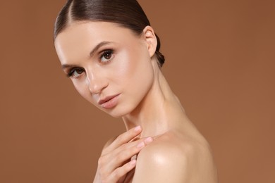 Photo of Portrait of beautiful young woman on beige background