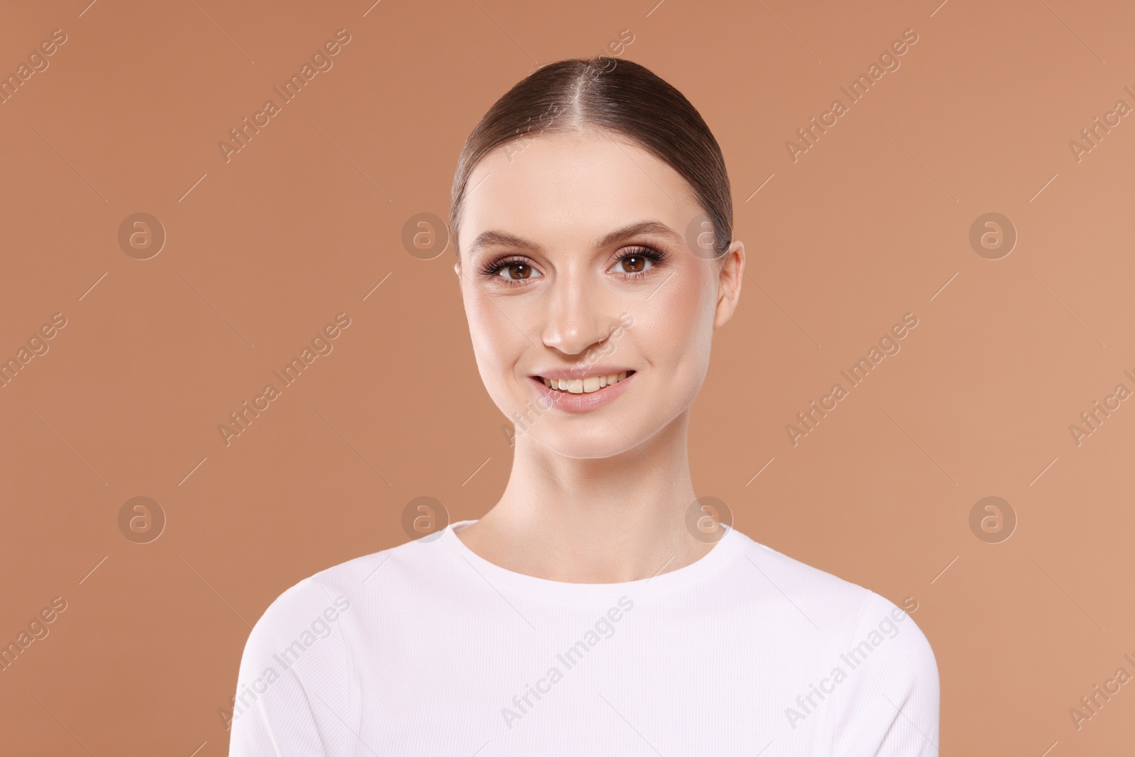 Portrait of beautiful young woman on beige background Photo of Portrait of beautiful young woman on beige background