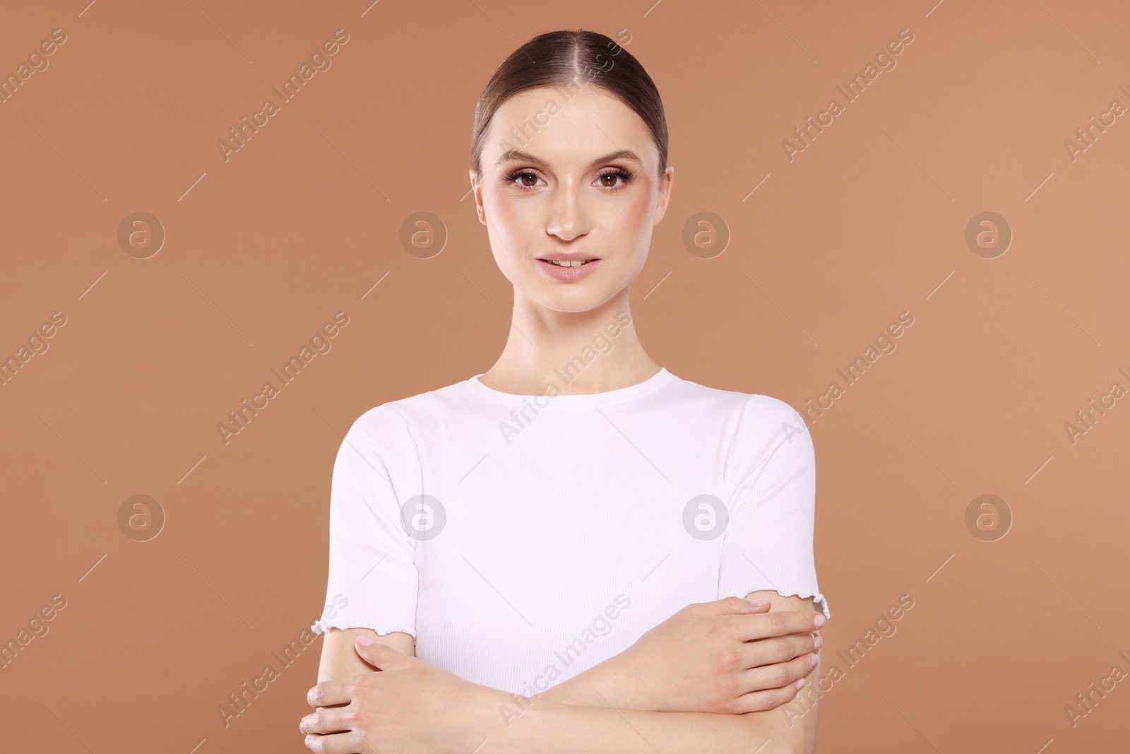 Portrait of beautiful young woman on beige background Photo of Portrait of beautiful young woman on beige background