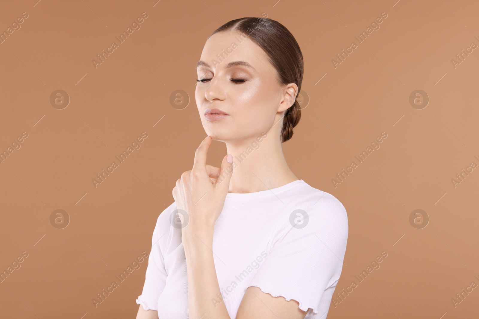 Portrait of beautiful young woman on beige background Photo of Portrait of beautiful young woman on beige background