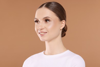 Photo of Portrait of beautiful young woman on beige background