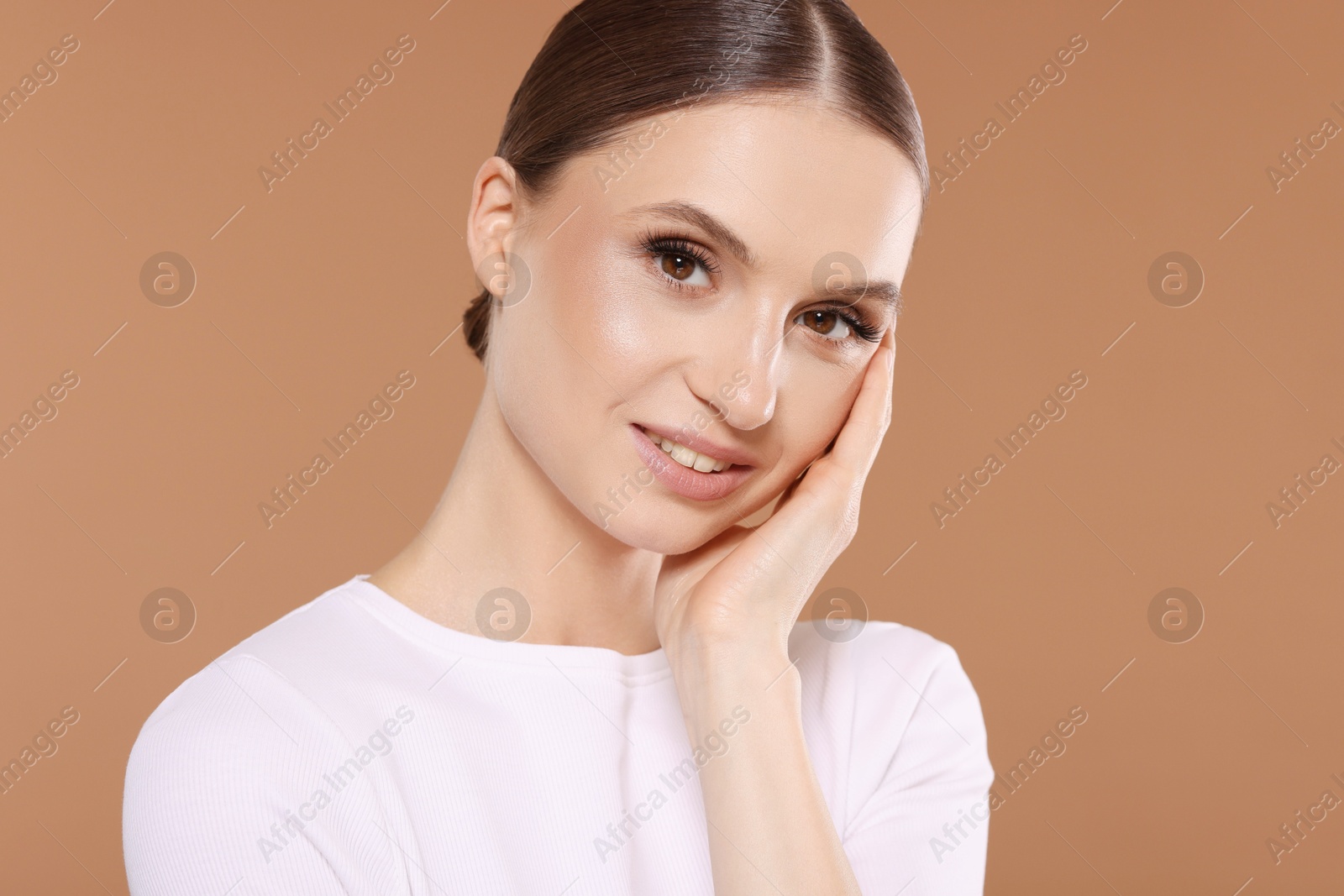 Portrait of beautiful young woman on beige background Photo of Portrait of beautiful young woman on beige background