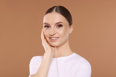 Photo of Portrait of beautiful young woman on beige background