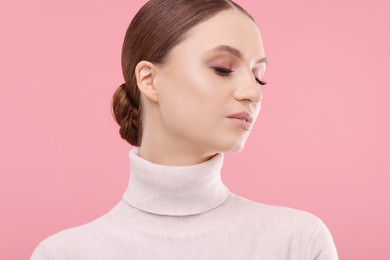 Photo of Portrait of beautiful young woman on pink background,