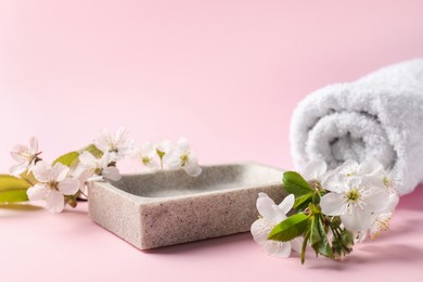 Photo of Spa composition with beautiful flowers on pink background, closeup. Space for text