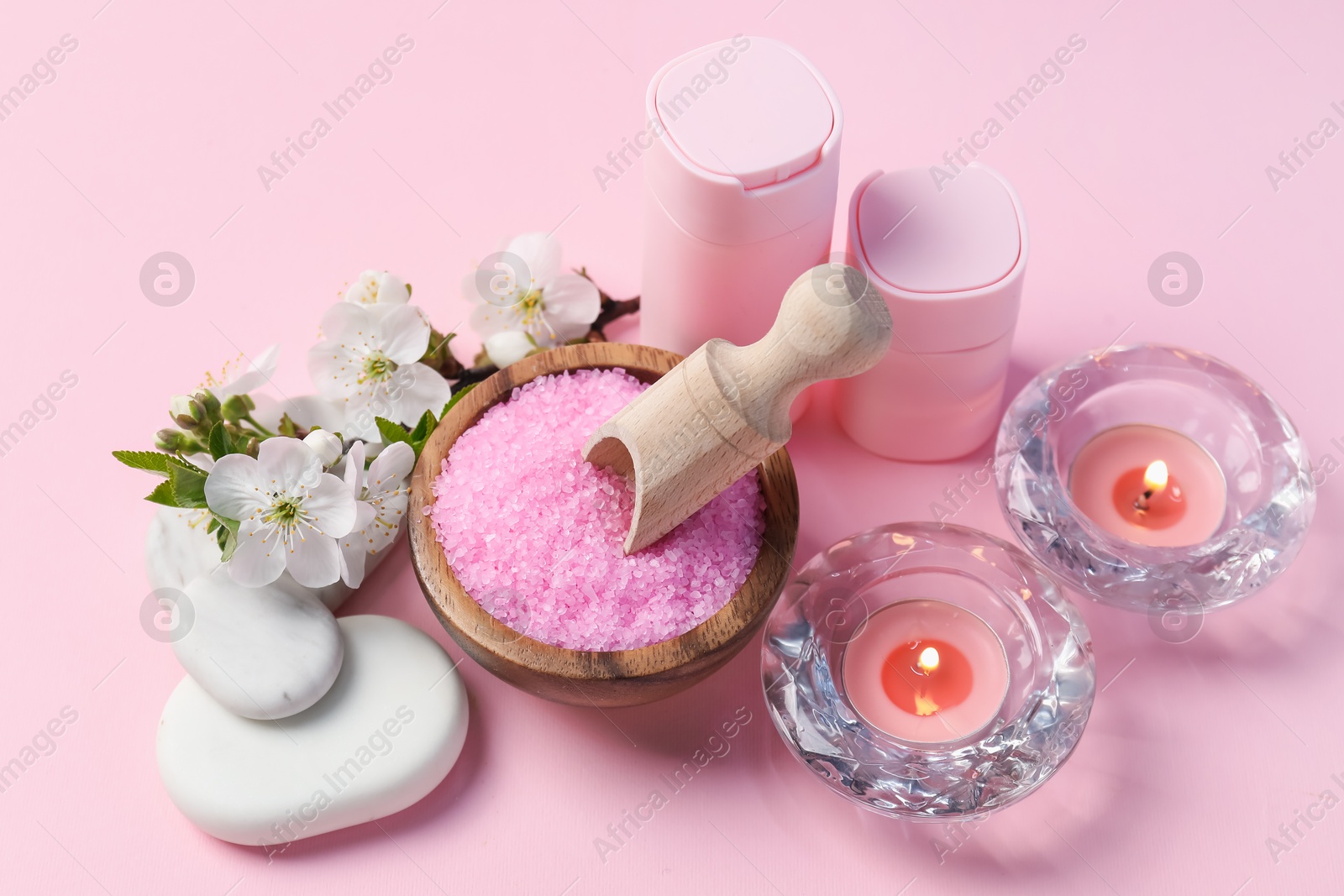 Spa composition with cosmetic products, pebble stones and beautiful flowers on pink background, above view Photo of Spa composition with cosmetic products, pebble stones and beautiful flowers on pink background, above view