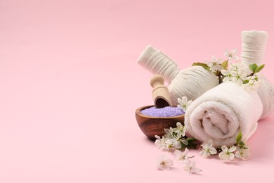 Photo of Spa composition with beautiful flowers on pink background, closeup. Space for text