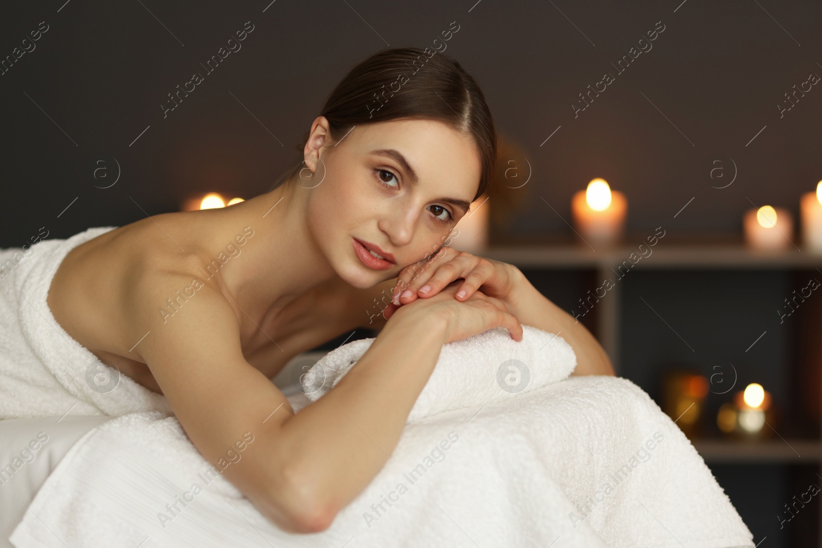 Beautiful woman relaxing on massage couch in spa salon Photo of Beautiful woman relaxing on massage couch in spa salon