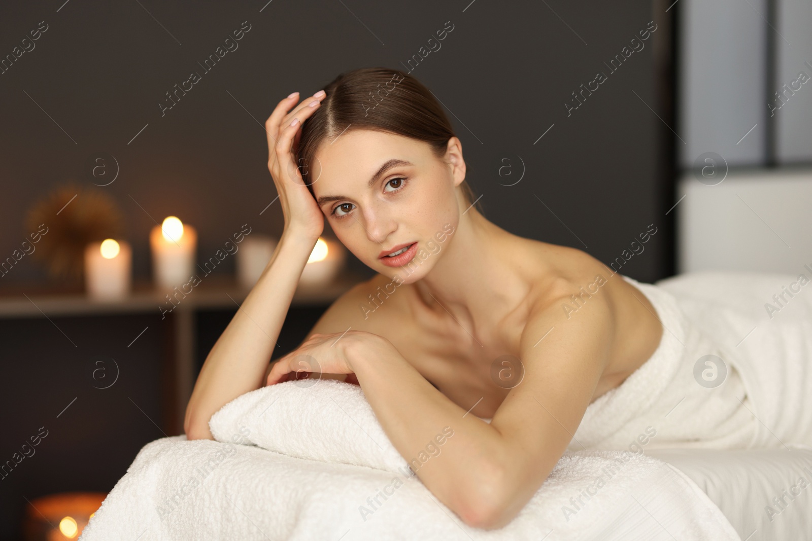 Beautiful woman relaxing on massage couch in spa salon Photo of Beautiful woman relaxing on massage couch in spa salon