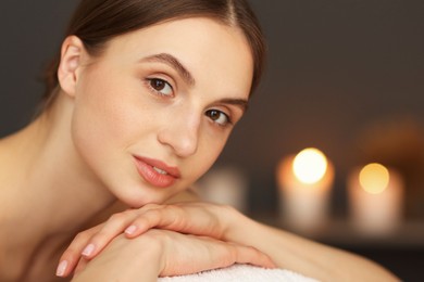Photo of Beautiful woman relaxing in spa salon, closeup
