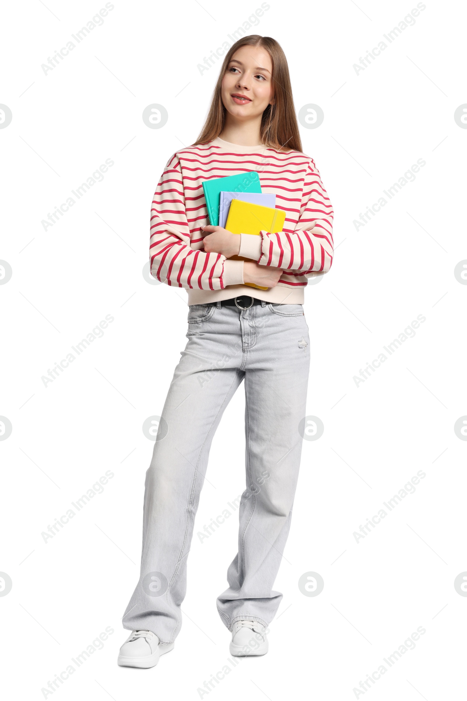 Teenage girl with notebooks on white background Photo of Teenage girl with notebooks on white background