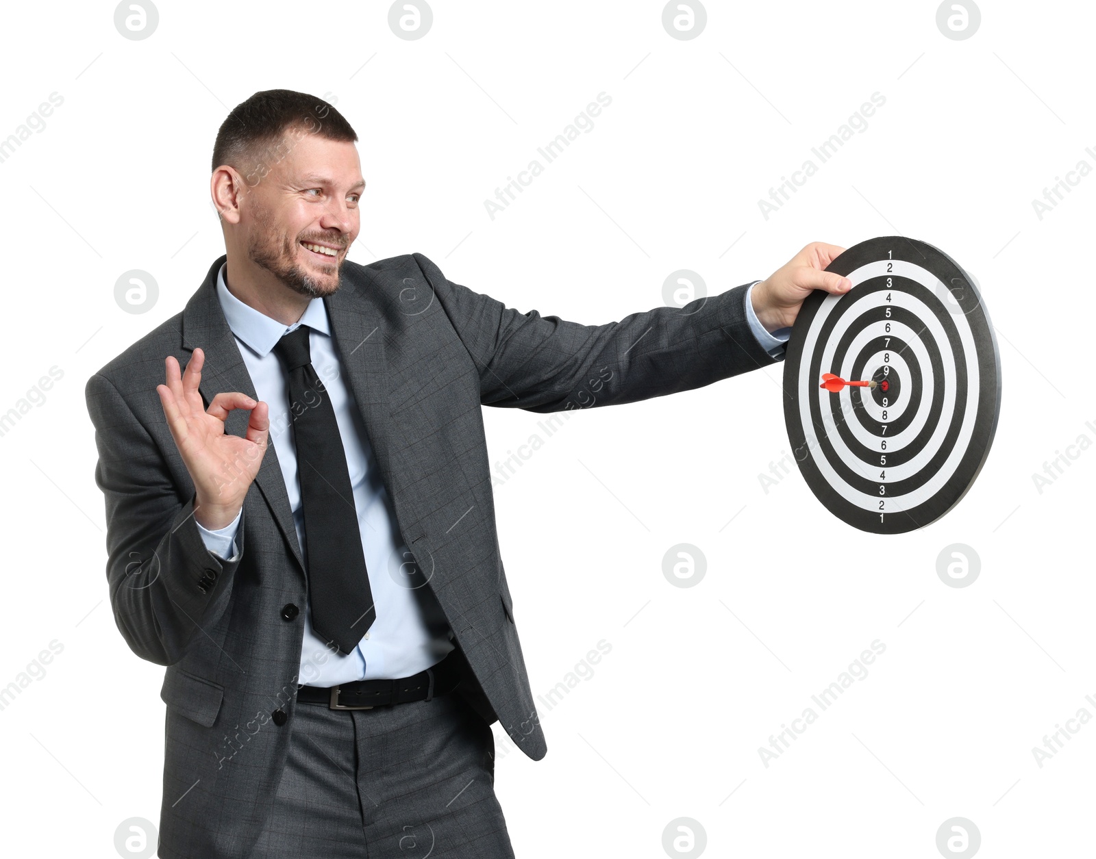 Targeting. Man with dart board and arrow showing ok gesture on white background Photo of Targeting. Man with dart board and arrow showing ok gesture on white background