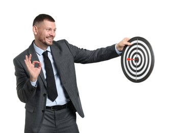 Photo of Targeting. Man with dart board and arrow showing ok gesture on white background