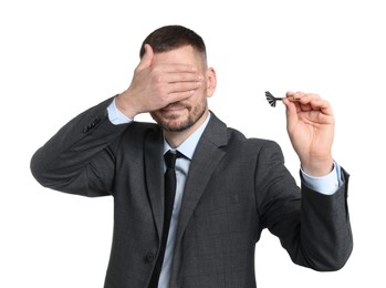Photo of Targeting. Man with dart covering eyes on white background