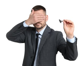 Photo of Targeting. Man with dart covering eyes on white background