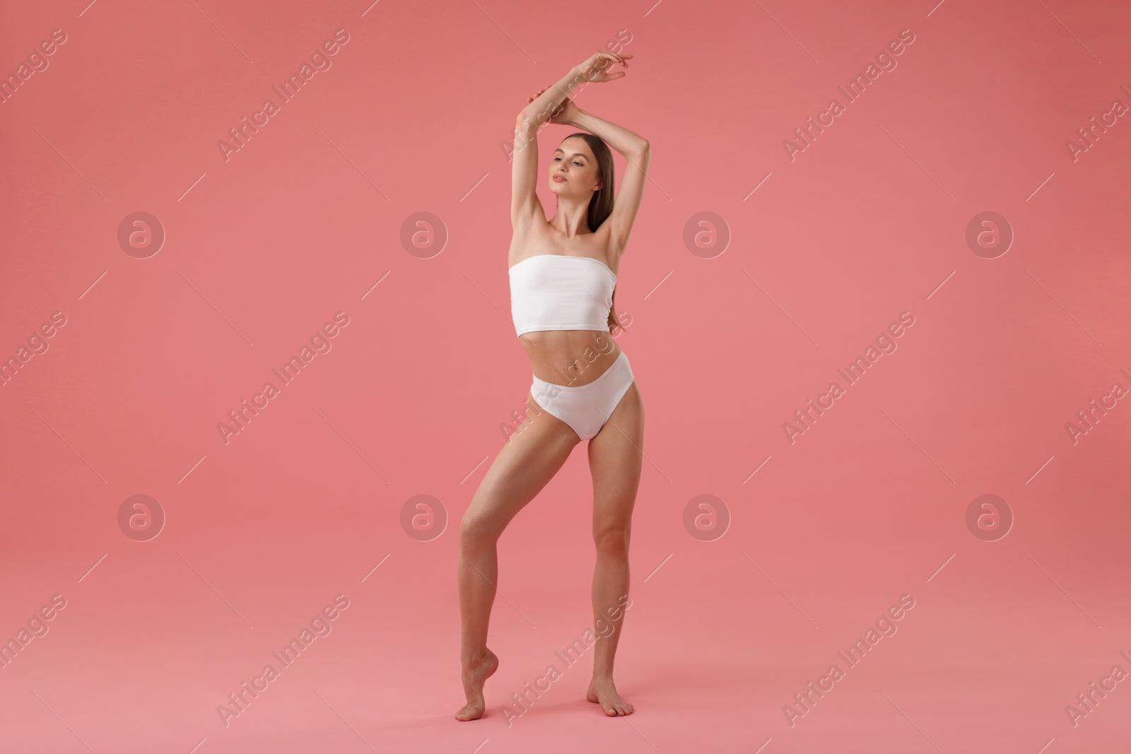 Beautiful woman with perfect slim body on pink background Photo of Beautiful woman with perfect slim body on pink background
