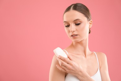 Photo of Beautiful woman with soap bar on pink background. Space for text