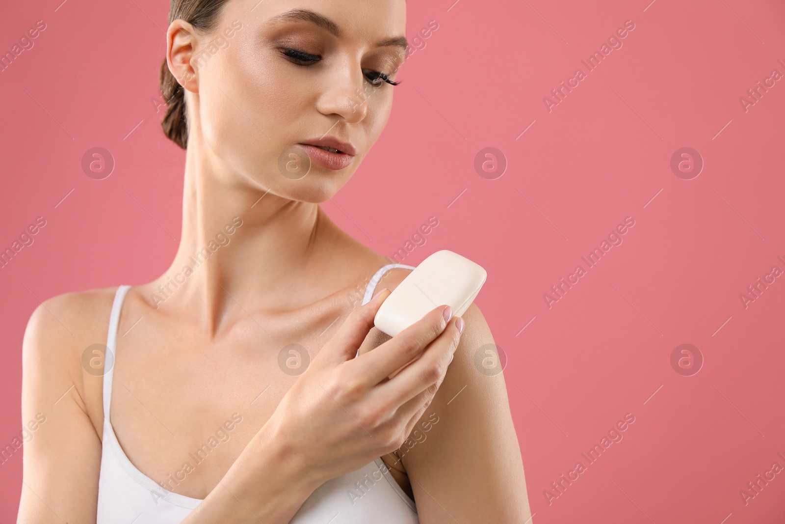 Beautiful woman with soap bar on pink background. Space for text Photo of Beautiful woman with soap bar on pink background. Space for text