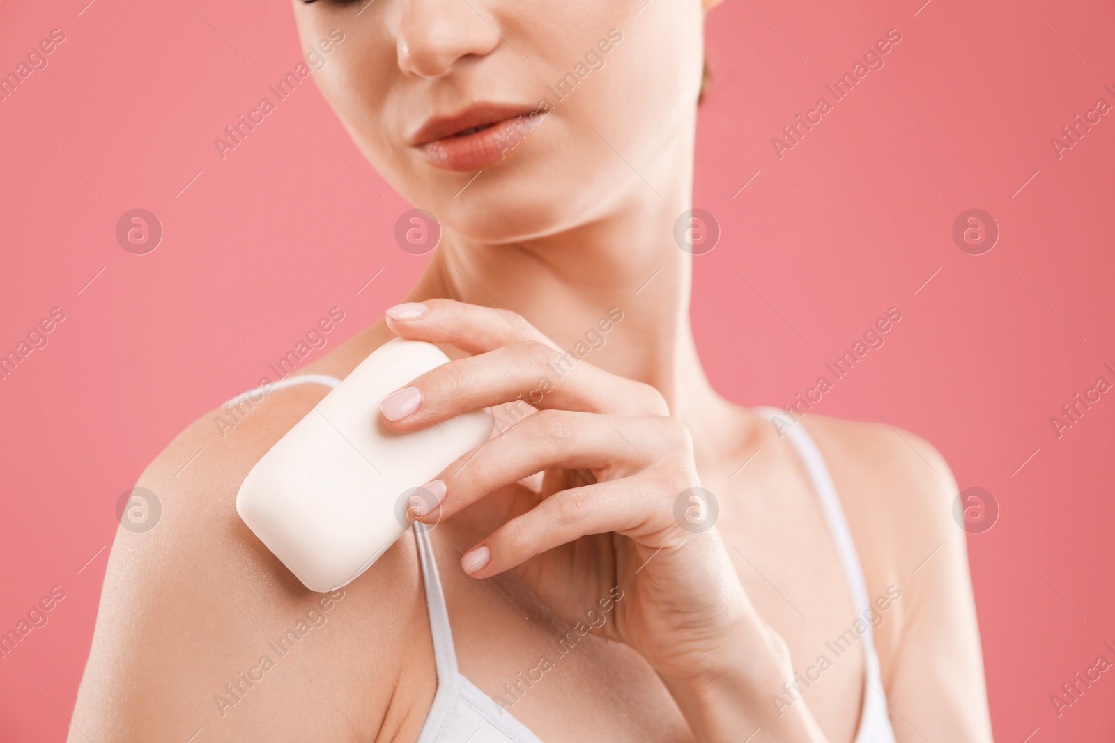 Woman with soap bar on pink background, closeup Photo of Woman with soap bar on pink background, closeup