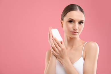 Photo of Beautiful woman with soap bar on pink background. Space for text
