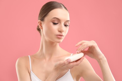 Photo of Beautiful woman with soap bar on pink background
