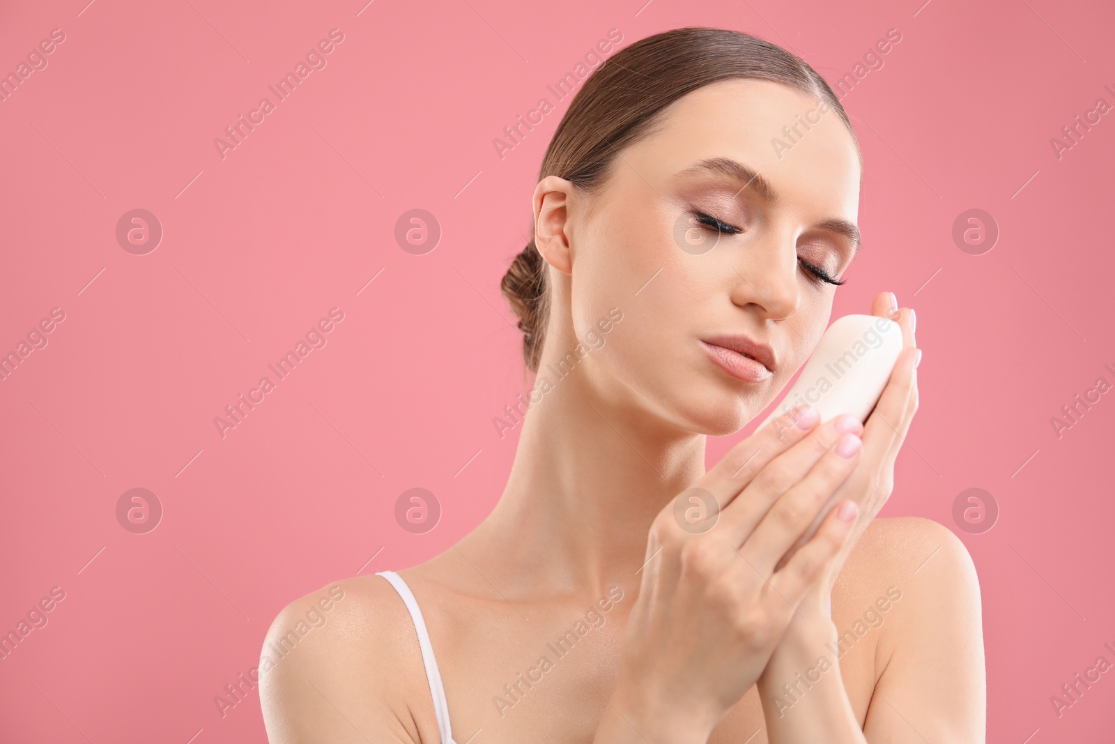 Beautiful woman with soap bar on pink background. Space for text Photo of Beautiful woman with soap bar on pink background. Space for text