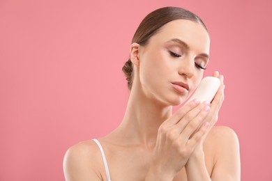 Photo of Beautiful woman with soap bar on pink background. Space for text