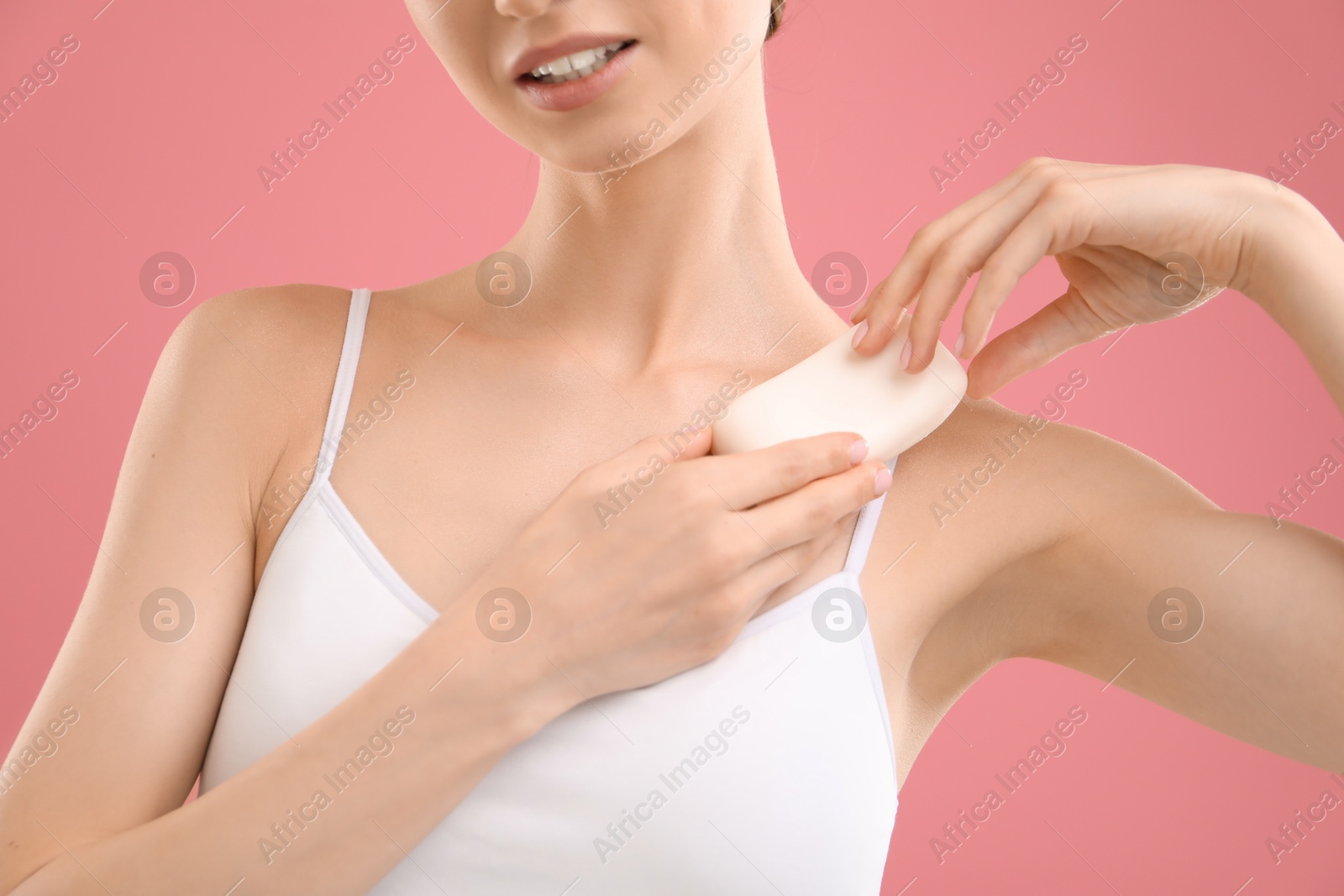 Woman with soap bar on pink background, closeup Photo of Woman with soap bar on pink background, closeup