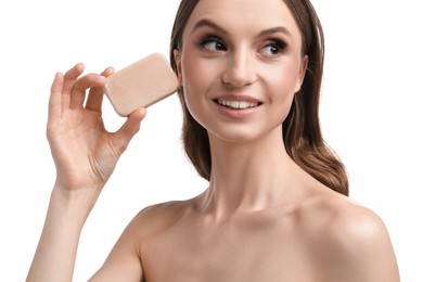 Photo of Smiling woman with soap bar on white background, closeup