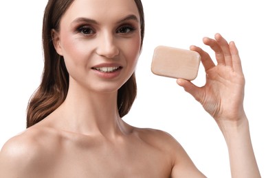 Photo of Smiling woman with soap bar on white background, closeup