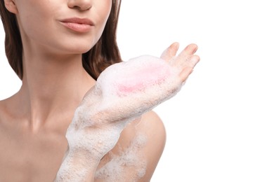 Photo of Woman with foaming soap bar on white background, closeup