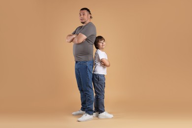 Photo of Father and his son on beige background