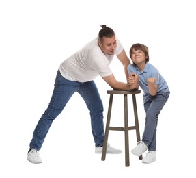Photo of Father with his son arm wrestling on white background