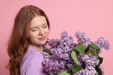 Photo of Portrait of beautiful teenage girl with lilac flowers on pink background