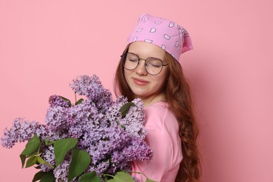 Photo of Portrait of beautiful teenage girl with lilac flowers on pink background