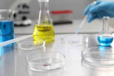 Photo of Scientist working in laboratory, focus on Petri dishes