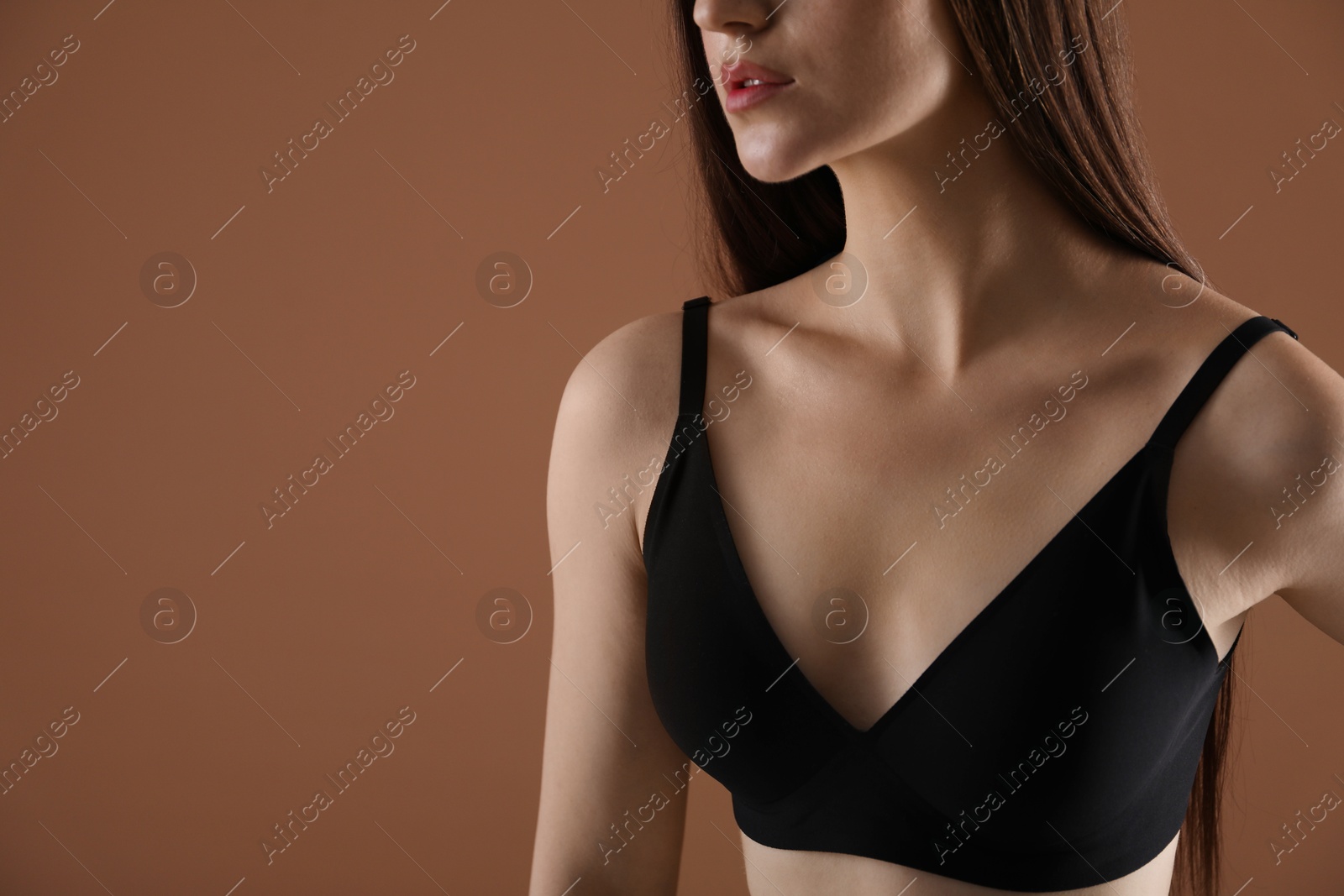 Woman with beautiful collarbone on brown background, closeup. Space for text Photo of Woman with beautiful collarbone on brown background, closeup. Space for text