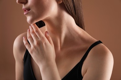 Photo of Woman with beautiful collarbone on brown background, closeup