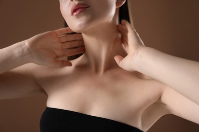 Photo of Woman with beautiful collarbones on brown background, closeup
