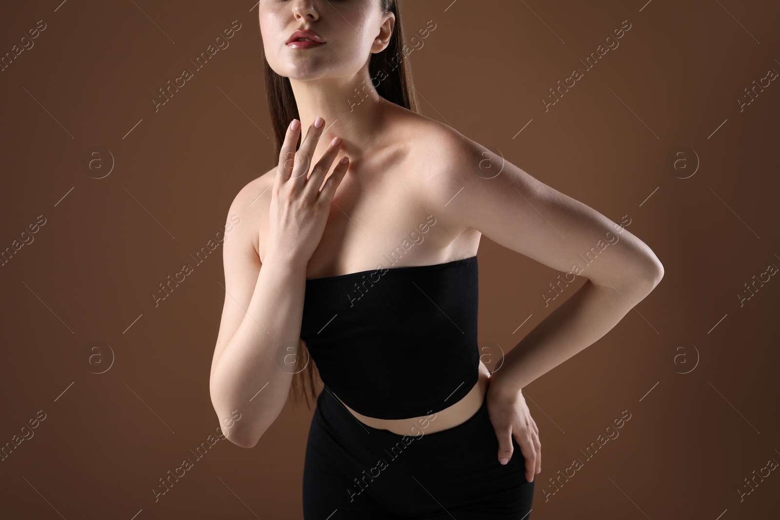 Woman with beautiful body on brown background, closeup Photo of Woman with beautiful body on brown background, closeup