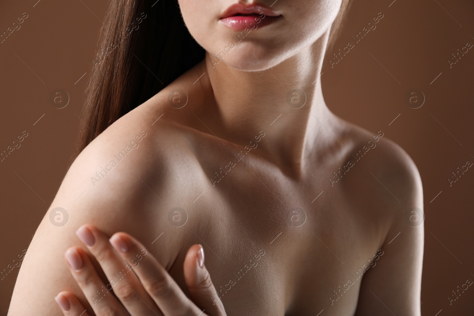 Woman with beautiful collarbones on brown background, closeup Photo of Woman with beautiful collarbones on brown background, closeup
