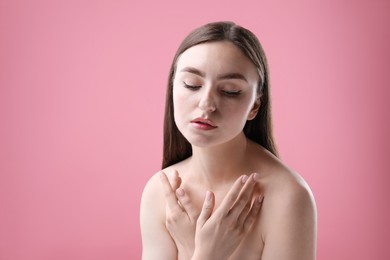 Photo of Portrait of beautiful woman on pink background. Space for text