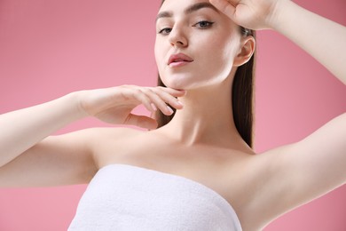 Photo of Portrait of beautiful woman on pink background
