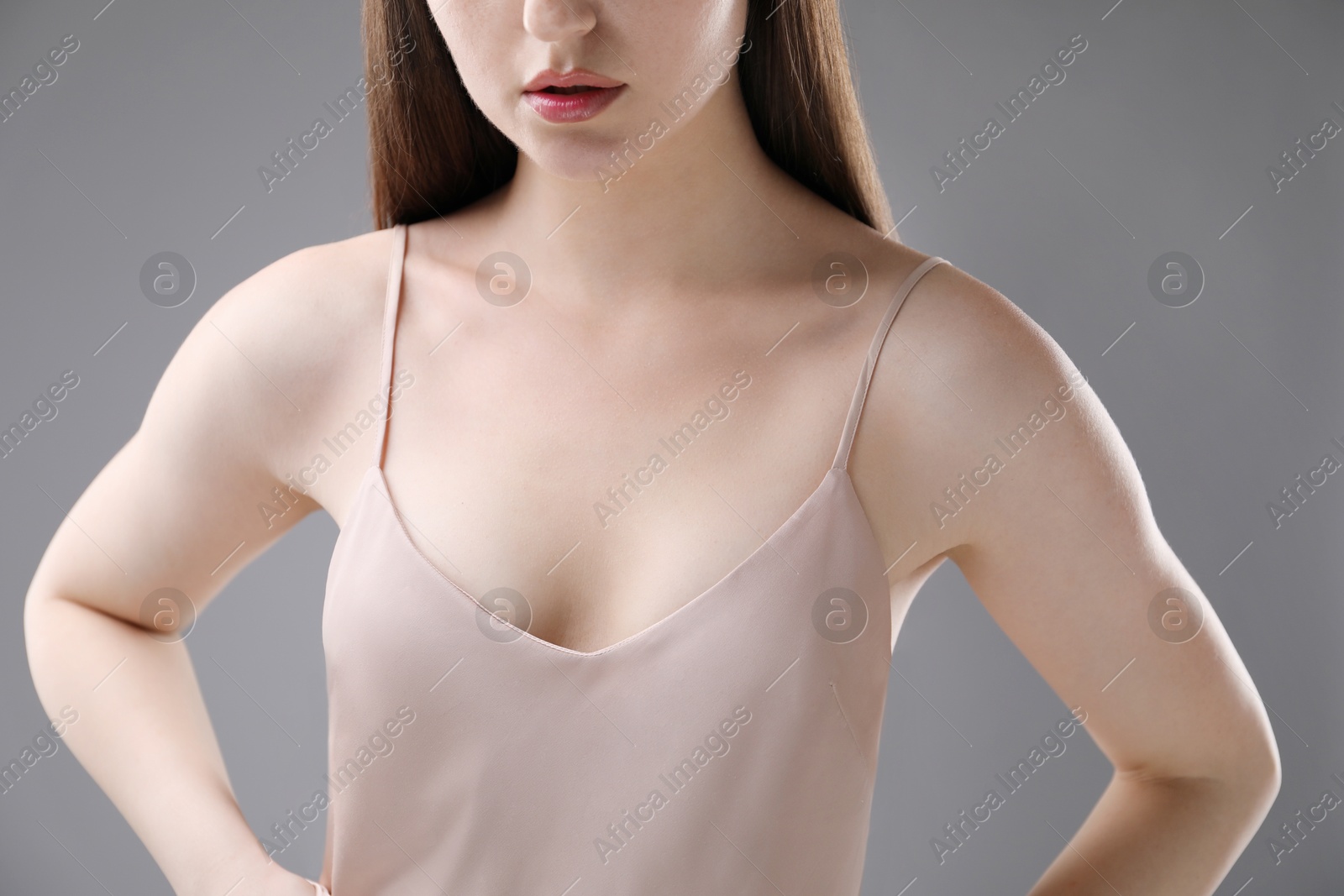 Woman with beautiful collarbones on grey background, closeup Photo of Woman with beautiful collarbones on grey background, closeup