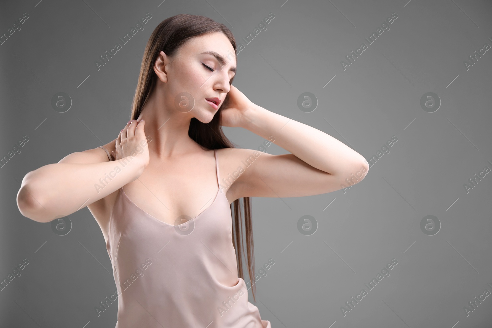 Portrait of beautiful woman on grey background. Space for text Photo of Portrait of beautiful woman on grey background. Space for text