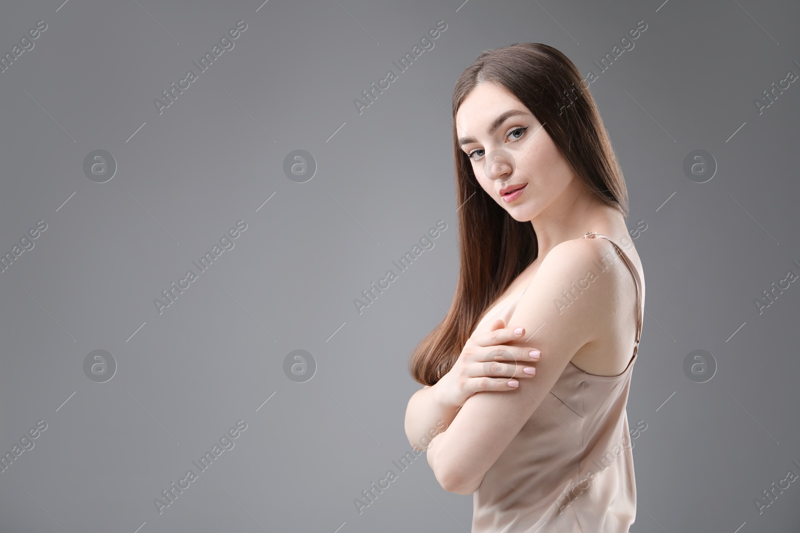 Portrait of beautiful woman on grey background. Space for text Photo of Portrait of beautiful woman on grey background. Space for text